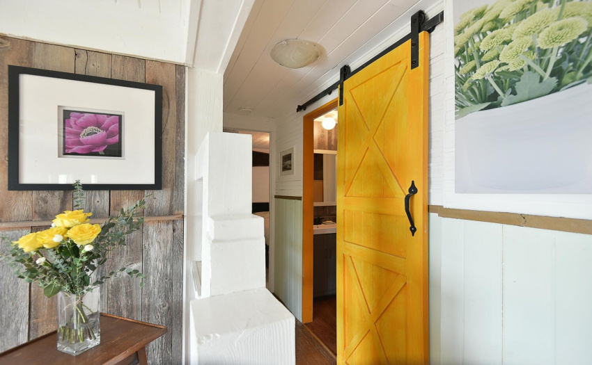 Hallway to main bedroom -  barn door on bathroom provides a charming detail with accent color!