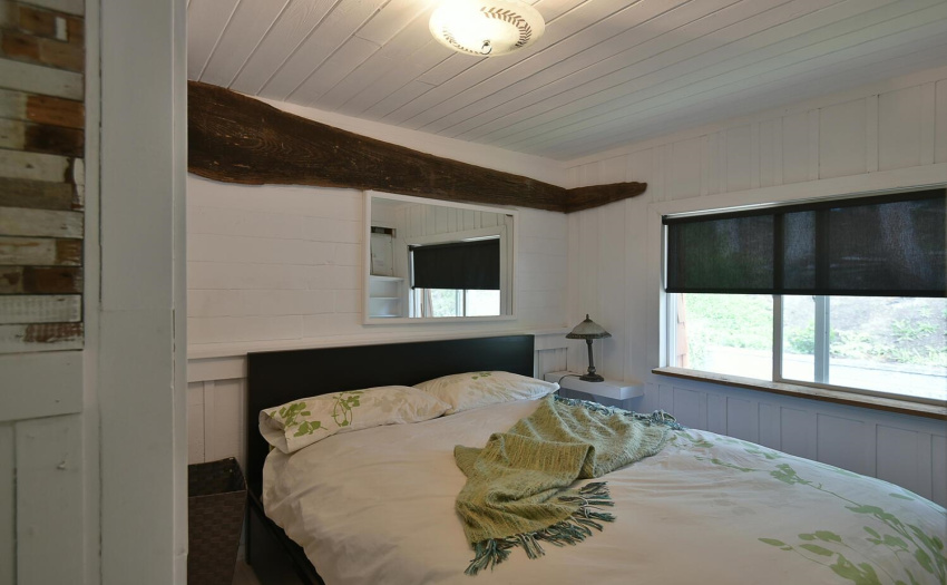 Main bedroom is cozy with built in book shelves and a closet.